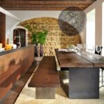 Moderne Wohnwand mit TV-Lowboard und Hängeschränken in Holzoptik von Anrei Stamm.